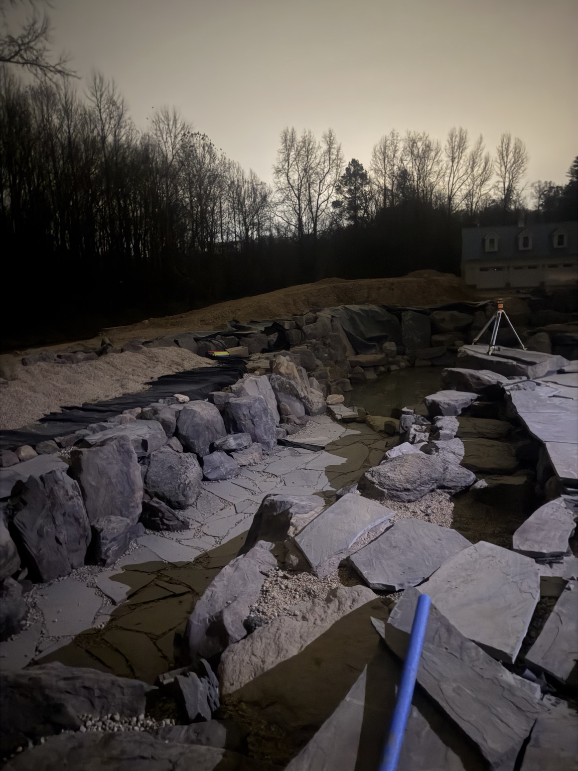 Naturalistic pond construction with stonework underway in Virginia