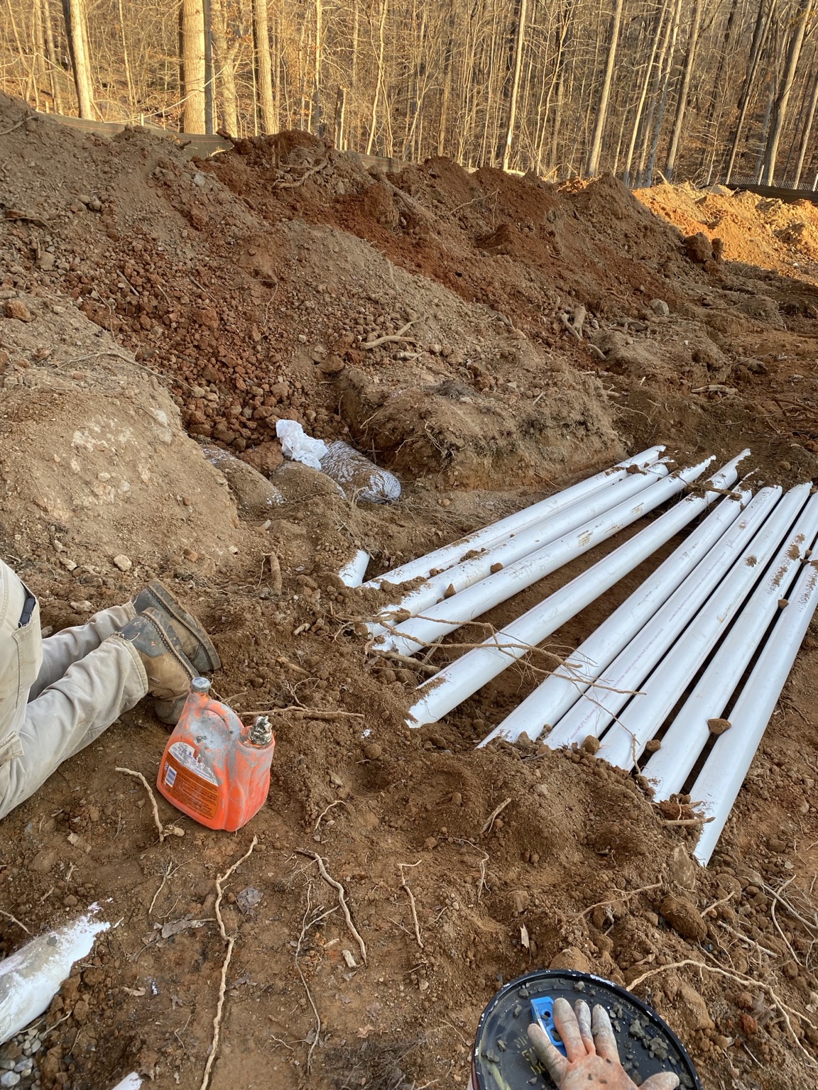 Septic drainfield piping installation in excavated Virginia soil